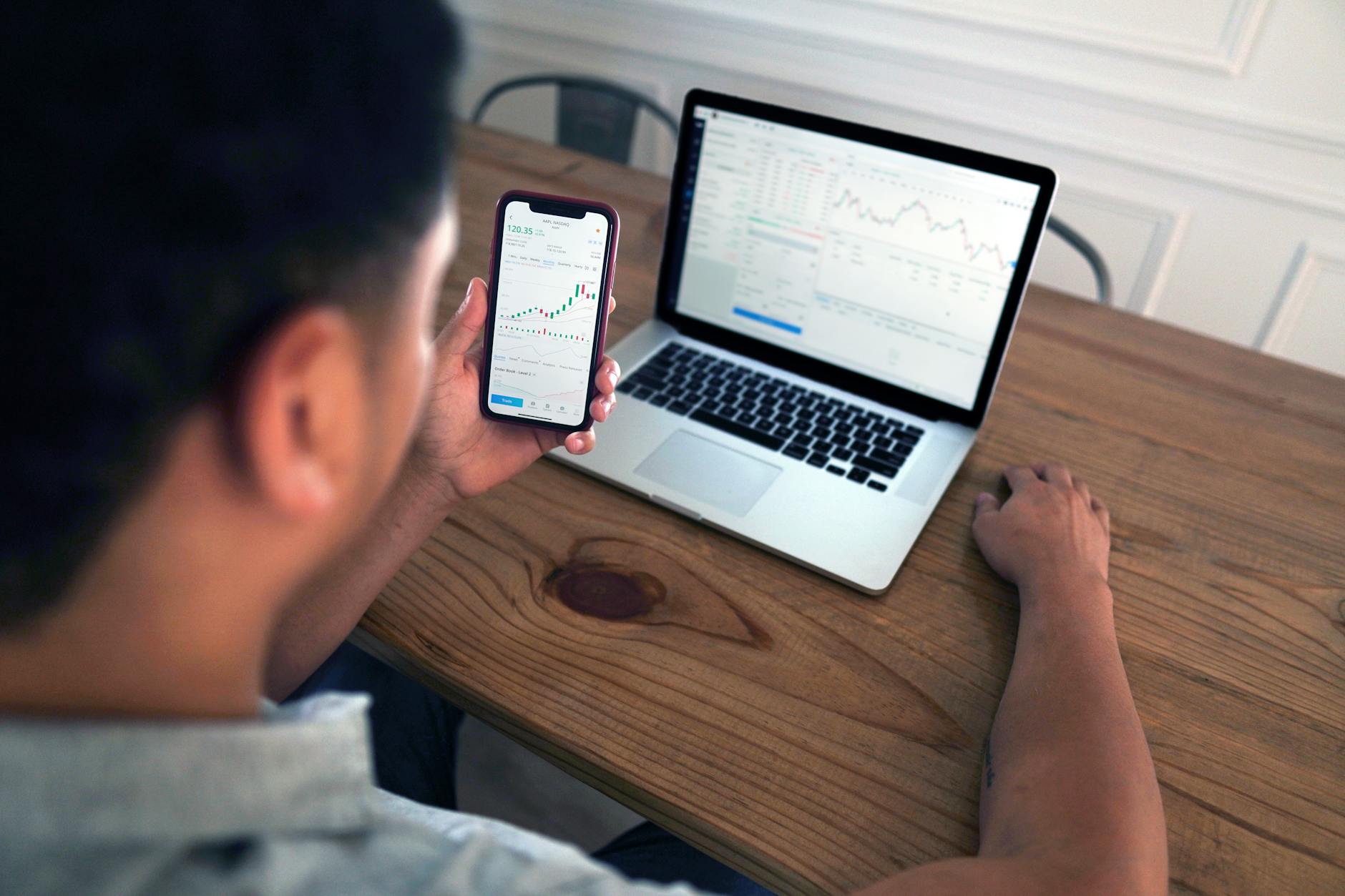 a person using smartphone and laptop